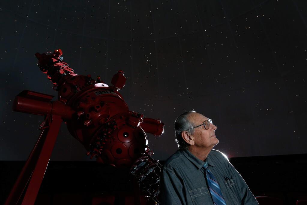Planetarium director Ed Megill, 75, sits beside the star projector as it displays the night sky across the planetarium dome in Lark Hall at Santa Rosa Junior College in Santa Rosa, California on Friday, March 11, 2016. (Alvin Jornada / The Press Democrat)