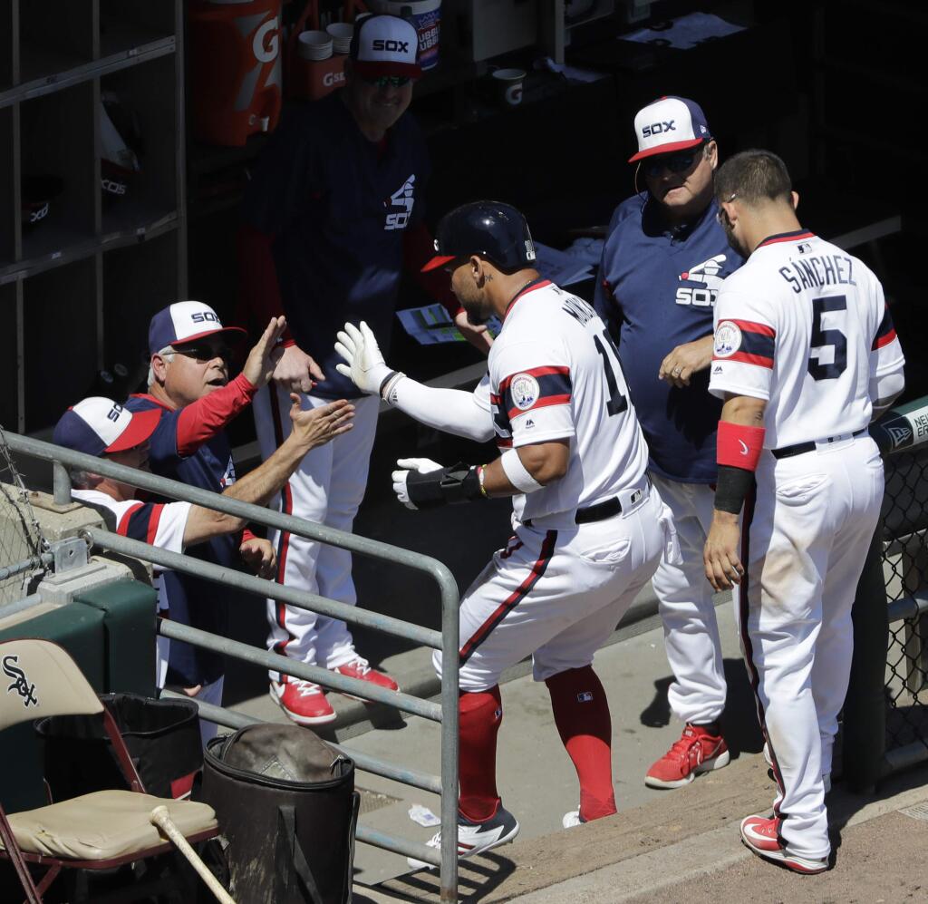 Chicago White Sox's Yoan Moncada, center, celebrates with manager Rick Renteria and teammates after scoring on a single by Avisail Garcia during the fifth inning of a baseball game against the Oakland Athletics, Sunday, June 24, 2018, in Chicago. (AP Photo/Nam Y. Huh)