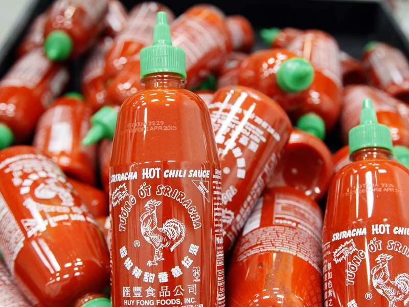 Sriracha chili sauce bottles are produced at the Huy Fong Foods factory in Irwindale, Calif., on Tuesday, Oct 29, 2013. (AP Photo/Nick Ut)
