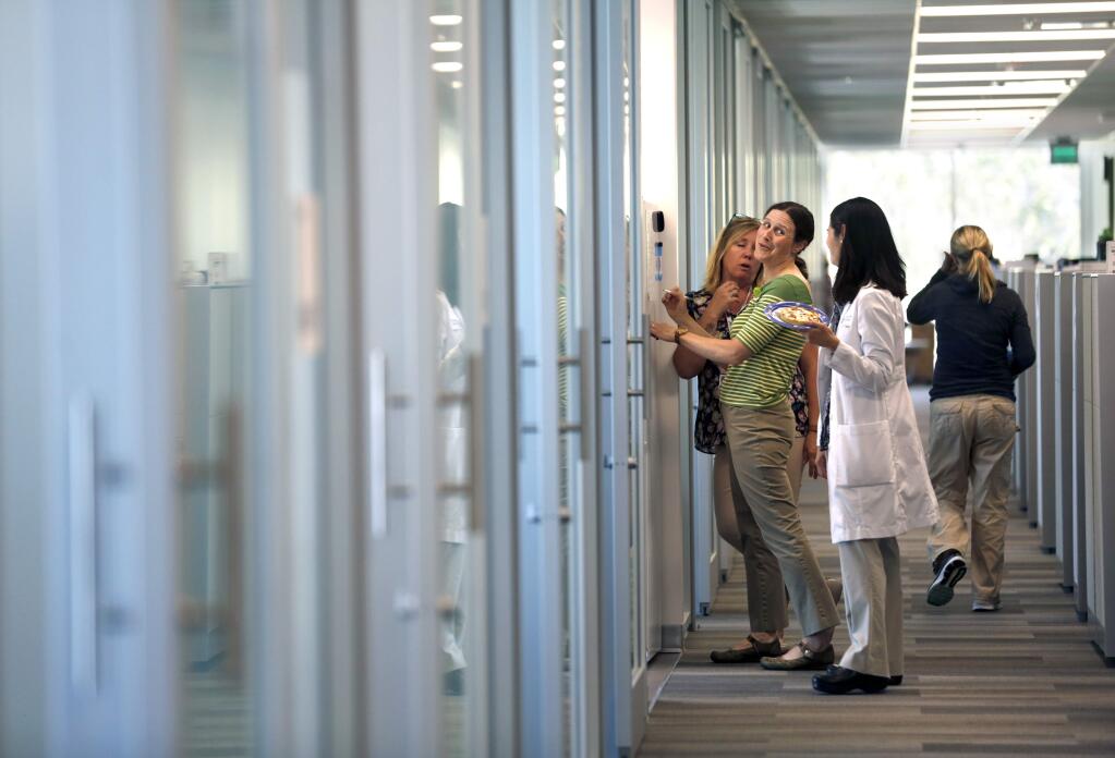 Dr. Maya Land, center, talks with Dr. Anna Dematteis, right, at Kaiser Permanente's new medical clinic located at 2240 Mercury Way in Santa Rosa on Tuesday, May 29, 2018. (Beth Schlanker/ The Press Democrat)