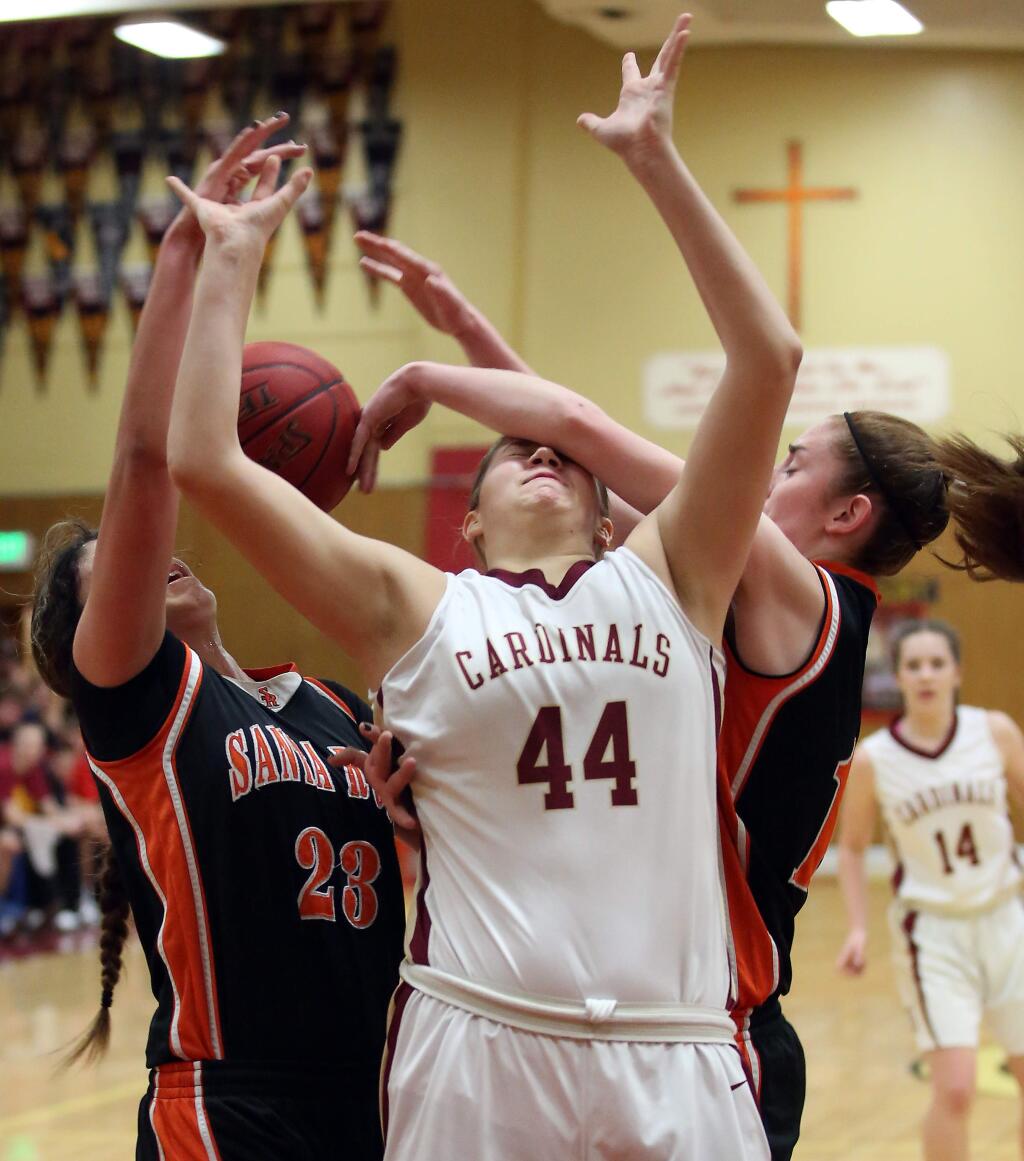 Cardinal Newman's Lauren Walker, center, looses the ball as Santa Rosa's Kylie Oden, right, and Mireya Lopez, left, pressure her during the game held at Cardinal Newman High School, Tuesday, February 10, 2015. (Crista Jeremiason / The Press Democrat)