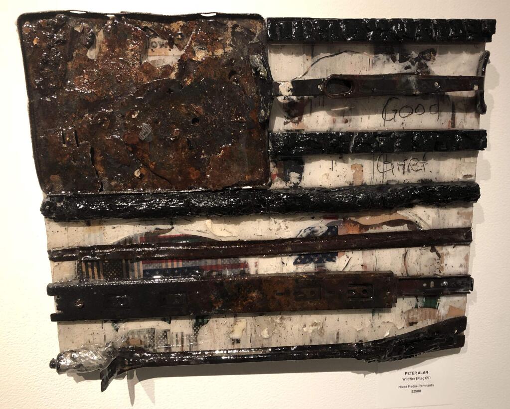 WILDFIRE (Flag 05) - Mixed-Media/Remnants by Peter Alan. One of a series of 'fire flags' constructed from materials pulled from the remains of his home.(PHOTO BY DAVID TEMPLETON)
