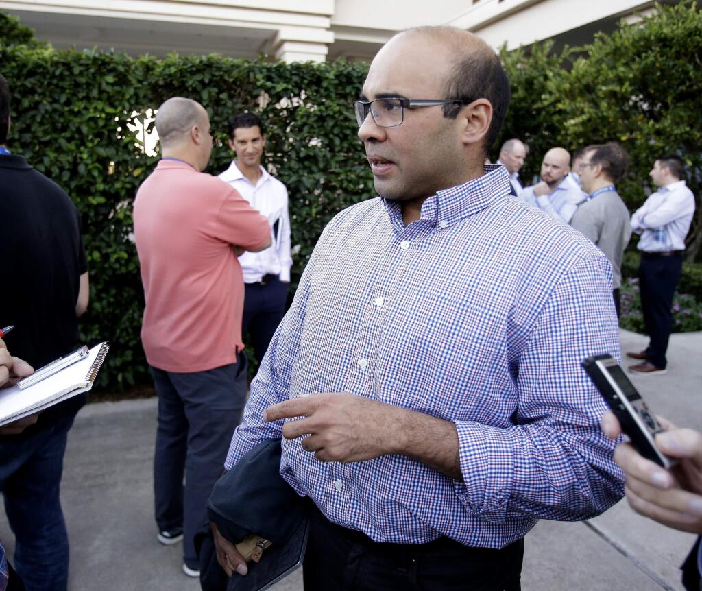 Farhan Zaidi, then general manager of the Los Angeles Dodgers, talks with members of the media at the annual general managers' meetings, Monday, Nov. 13, 2017, in Orlando, Fla. (AP Photo/John Raoux)