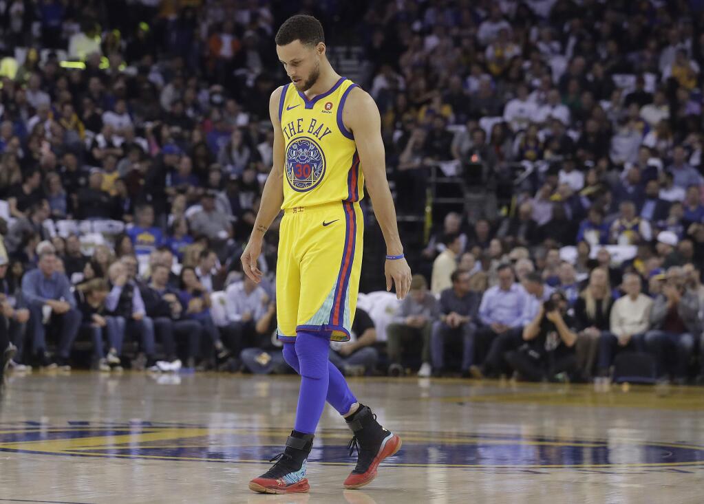 Golden State Warriors guard Stephen Curry walks on the court to shoot free throws during the first half against the San Antonio Spurs in Oakland, Thursday, March 8, 2018. (AP Photo/Jeff Chiu)