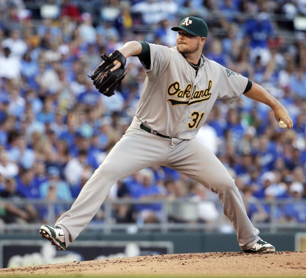 Oakland Athletics starting pitcher Jon Lester throws during the first inning of a baseball game against the Kansas City Royals, Tuesday, Aug. 12, 2014, in Kansas City, Mo. (AP Photo/Charlie Riedel)