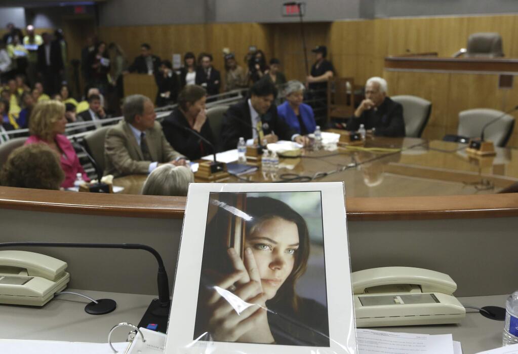 FILE - In this March 25, 2015, file photo, a portrait of Brittany Maynard sits on the dais of the Senate Health Committee as lawmakers heard testimony on proposed legislation allowing doctors to prescribe life-ending medication to terminally ill patients, at the Capitol in Sacramento, Calif. A California judge on Tuesday, May15, 2018, threw out a 2016 state law allowing the terminally ill to end their lives, ruling it was unconstitutionally approved by the Legislature. Maynard moved to Oregon from California to legally end her life in 2014. (AP Photo/Rich Pedroncelli, File)