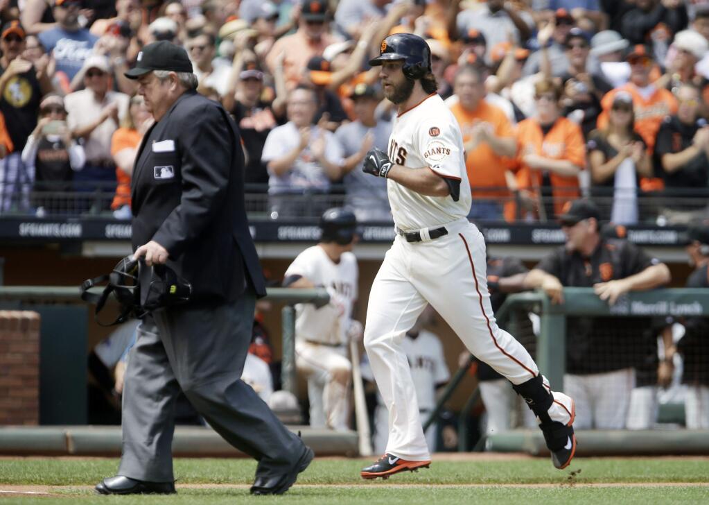 San Francisco Giants pitcher Madison Bumgarner runs the bases after hitting a home run off Oakland Athletics' Chris Bassitt in the third inning of a game Saturday, July 25, 2015, in San Francisco. (AP Photo/Ben Margot)
