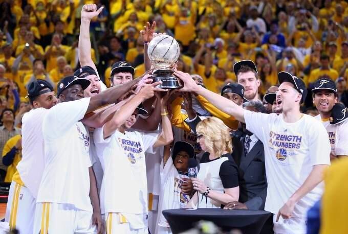 The Golden State Warriors hoist the conference trophy following Game 5 of the NBA Playoffs Western Conference Finals at Oracle Arena, in Oakland on Wednesday, May 27, 2015.(Christopher Chung/ The Press Democrat)