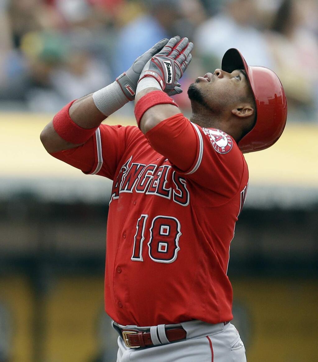 In this Sept. 4, 2017, file photo, the Los Angeles Angels' Luis Valbuena celebrates after hitting a three-run home run off the Oakland Athletics' Chris Smith in the second inning in Oakland. Former Major League Baseball players Luis Valbuena and Jose Castillo have been killed in a car crash in Venezuela. Both were playing for Cardenales de Lara in the Venezuelan league. (AP Photo/Ben Margot, FIle)