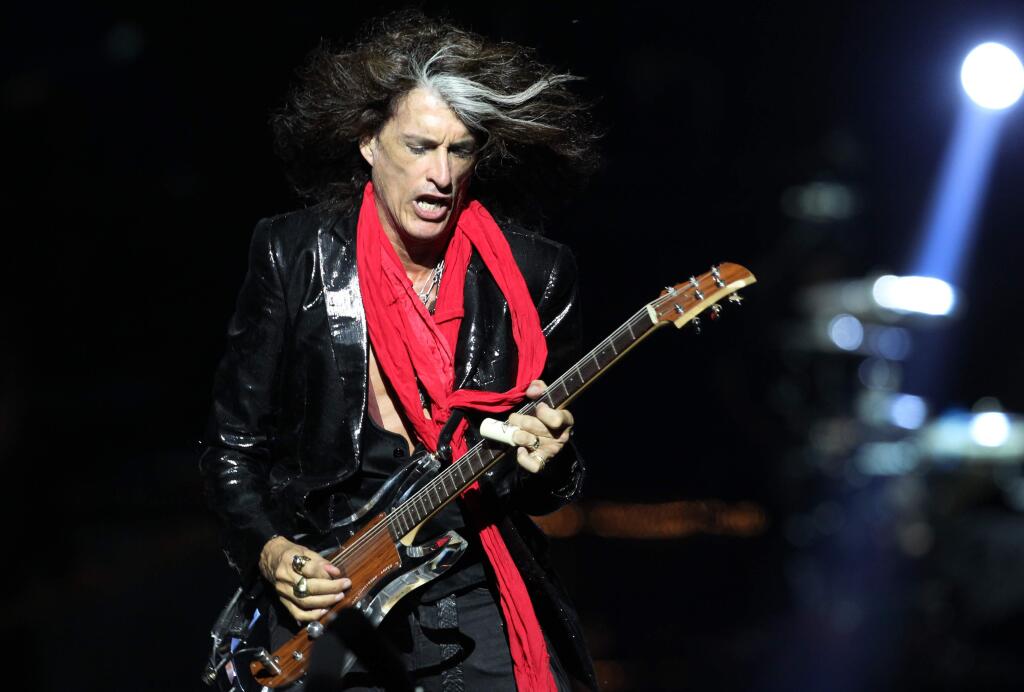 FILE - In this Saturday, May 25, 2013 file photo, lead guitarist Joe Perry, of American rock band Aerosmith, performs in Singapore during the inaugural Social Star Awards concert. Aerosmith co-founder and guitarist Perry has been taken to a hospital after he was forced to leave the stage while performing in New York City. Perry became ill on Sunday. July 11, 2016, while performing with Johnny Depp and Alice Cooper in his side band, the Hollywood Vampires, at Ford Amphitheater at the Coney Island boardwalk in Brooklyn. (AP Photo/Wong Maye-E, File)