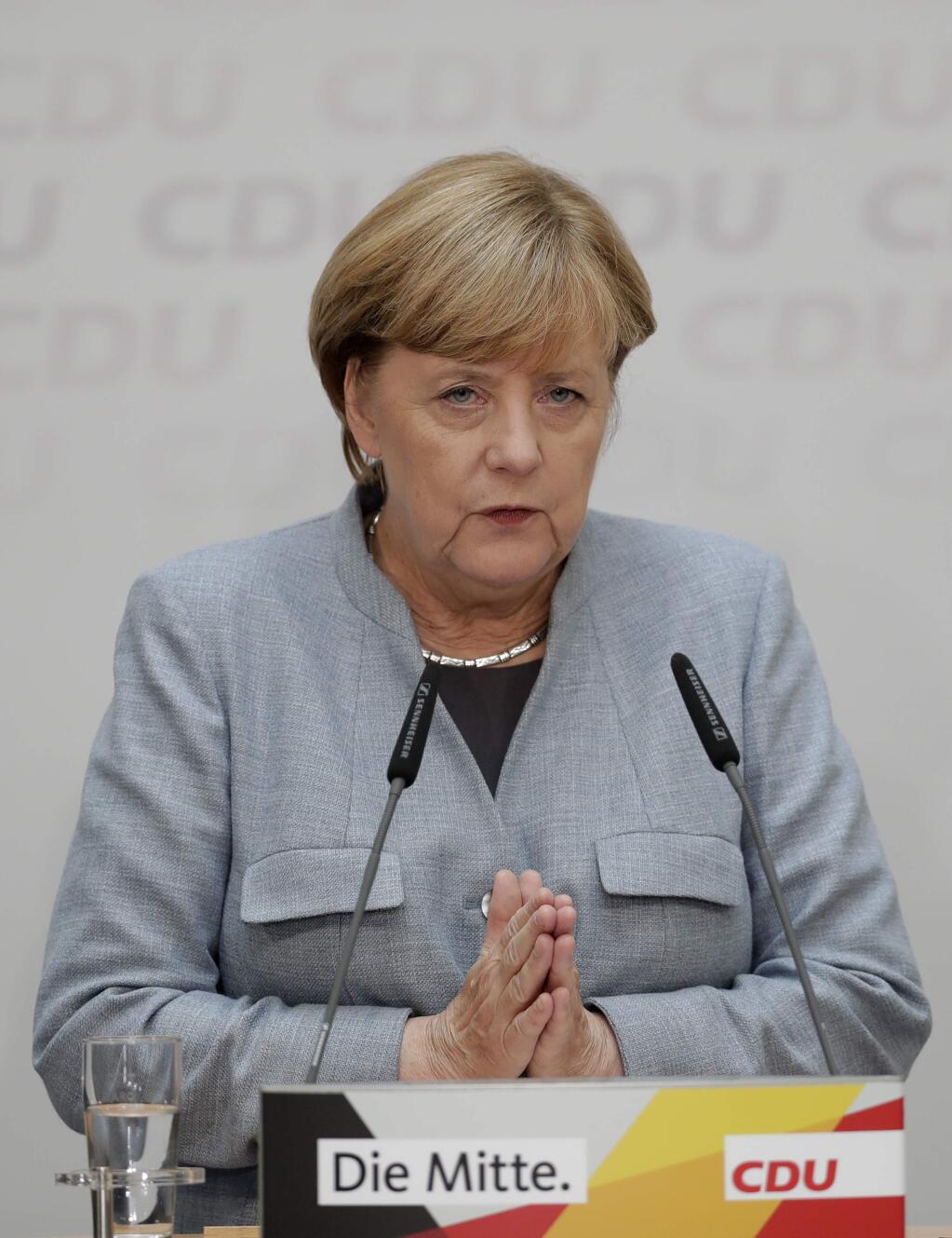 German Chancellor Angela Merkel speaks during a press conference after a board meeting of the Christian Democratic Union CDU in Berlin, Germany, Monday, Sept. 25, 2017, the day after the German parliament election. (AP Photo/Michael Sohn)