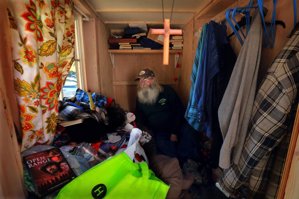 Former homeless man Russ Samson is now living in a closet-sided hut next to an office complex owned by former mayor Dave Berto. Samson has a bed window and storage under the bed for his books and clothing. (photo by John Burgess/The Press Democrat)