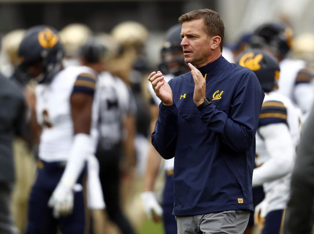 In this Oct. 28, 2017, photo, Cal head coach Justin Wilcox claps during the first half in Boulder, Colo. Wilcox has signed a new five-year deal to stay under contract with the school through the 2023 season. The deal signed Thursday, Dec. 6 2018, adds two more years to the original contract signed in 2017. (AP Photo/David Zalubowski, File)