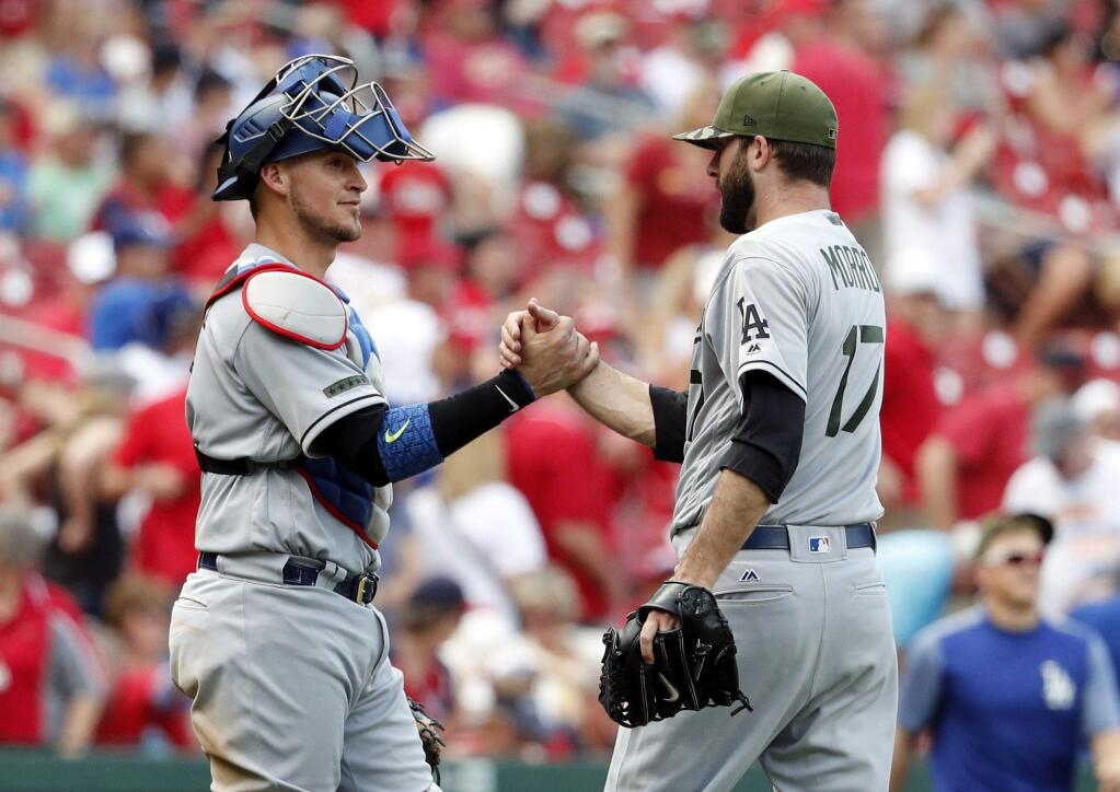 Los Angeles Dodgers relief pitcher Brandon Morrow, right, and catcher Yasmani Grandal celebrate following a baseball game against the St. Louis Cardinals Monday, May 29, 2017, in St. Louis. The Dodgers won 5-1. (AP Photo/Jeff Roberson)