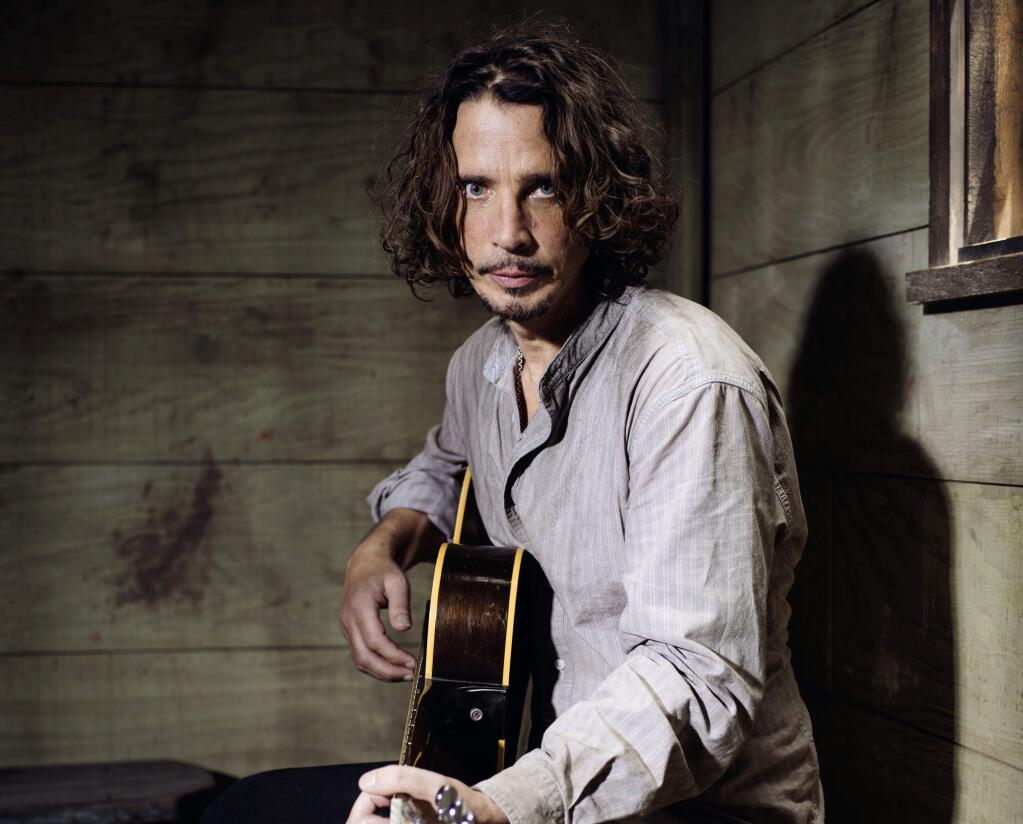 FILE - In this July 29, 2015 file photo, Chris Cornell plays guitar during a portrait session at The Paramount Ranch in Agoura Hills, Calif. (Photo by Casey Curry/Invision/AP, File)
