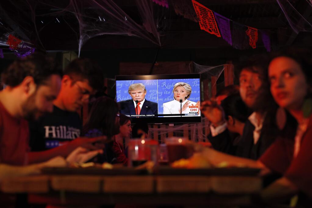 Customers watch the third and last U.S. presidential debate at the Pinche Gringo BBQ restaurant in Mexico City, Wednesday, Oct. 19, 2016. The debate was held in Las Vegas. (AP Photo/Dario Lopez-Mills)