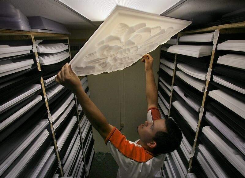 Alejandro Rodriguez (cq) holds aloft a transluscent ceiling tile in one of the many patterns made by Empire West, Inc. in their Graton factory,surrounded by shelves of samples. The lightweight ceiling tiles made of recyclable utility styrene are available as translucent or opaque or black. (PRESS DEMOCRAT/ MARK ARONOFF)