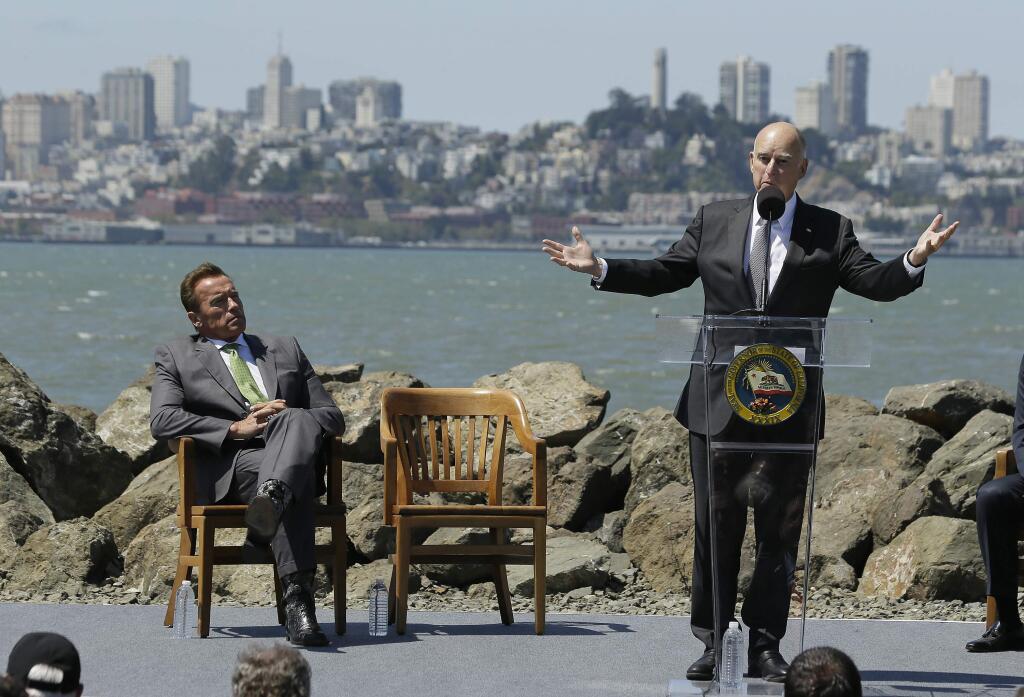 Gov. Jerry Brown, seen at a July news conference on Treasure Island with former Gov. Arnold Schwarzenegger, will host an international climate conference this week in San Francisco. (ERIC RISBERG / Associated Press)