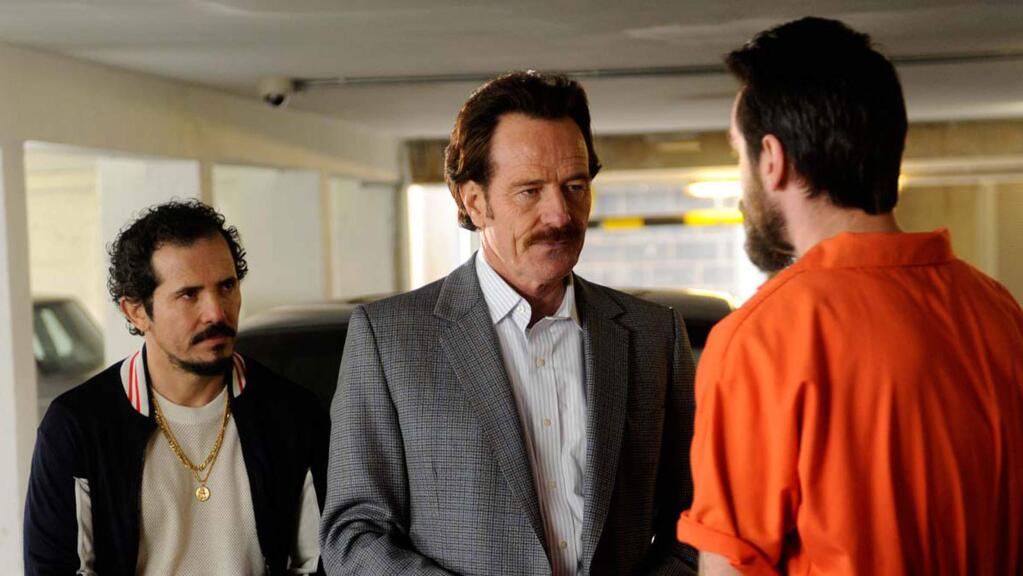 Bryan Cranston, center, and John Leguizamo, left, in 'The Infiltrator,' a drama based on a true story about U.S. Customs agent Bob Mazur who went deep undercover to infiltrate Pablo Escobar's blood-soaked drug trafficking cartel. (BROAD GREEN PICTURES)
