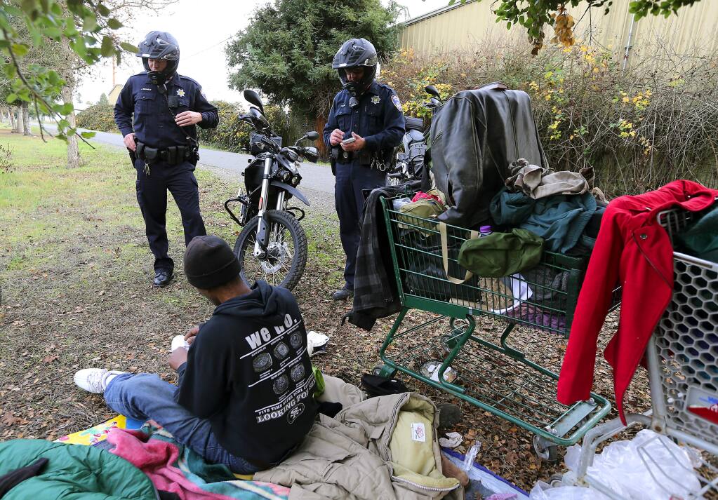 Santa Rosa police officers Jason Brandt, left, and Steve Pehlke use new electric motorcycles to quietly patrol the Joe Radota trail where they questioned a homeless man about his plans for finding shelter. (JOHN BURGESS / The Press Democrat)