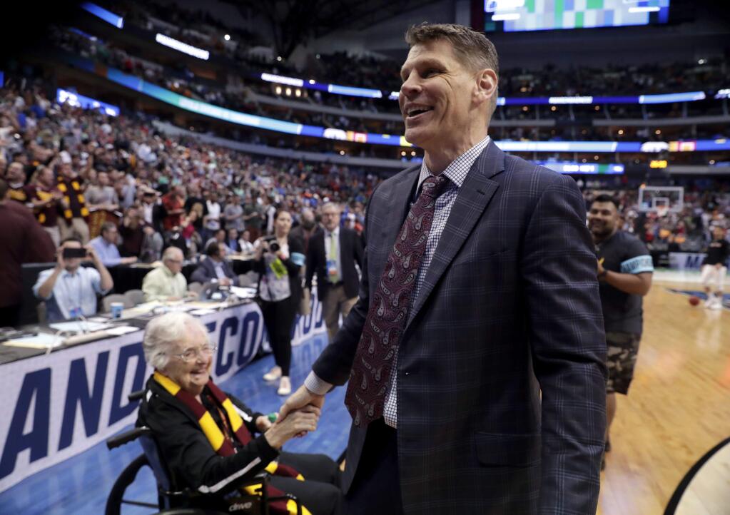 Sister Jean Dolores Schmidt, left, greets Loyola-Chicago coach Porter Moser after the team's 63-62 win over Tennessee in a second-round game at the NCAA men's college basketball tournament in Dallas, Saturday, March 17, 2018. (AP Photo/Tony Gutierrez)