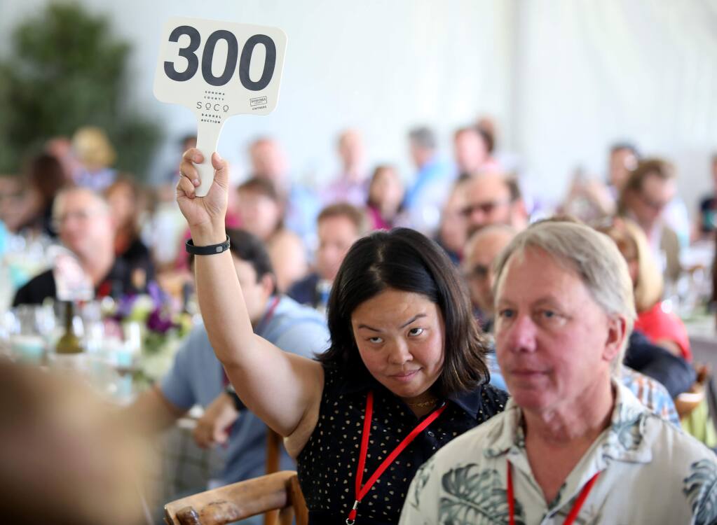 PHOTO: 1 BY CRISTA JEREMIASON/ THE PRESS DEMOCRAT -Limeng Stroh, bidding on behalf of Glen Knight, won a lot with a bid of $24,000 on Friday during the Sonoma County Barrel Auction in Santa Rosa.