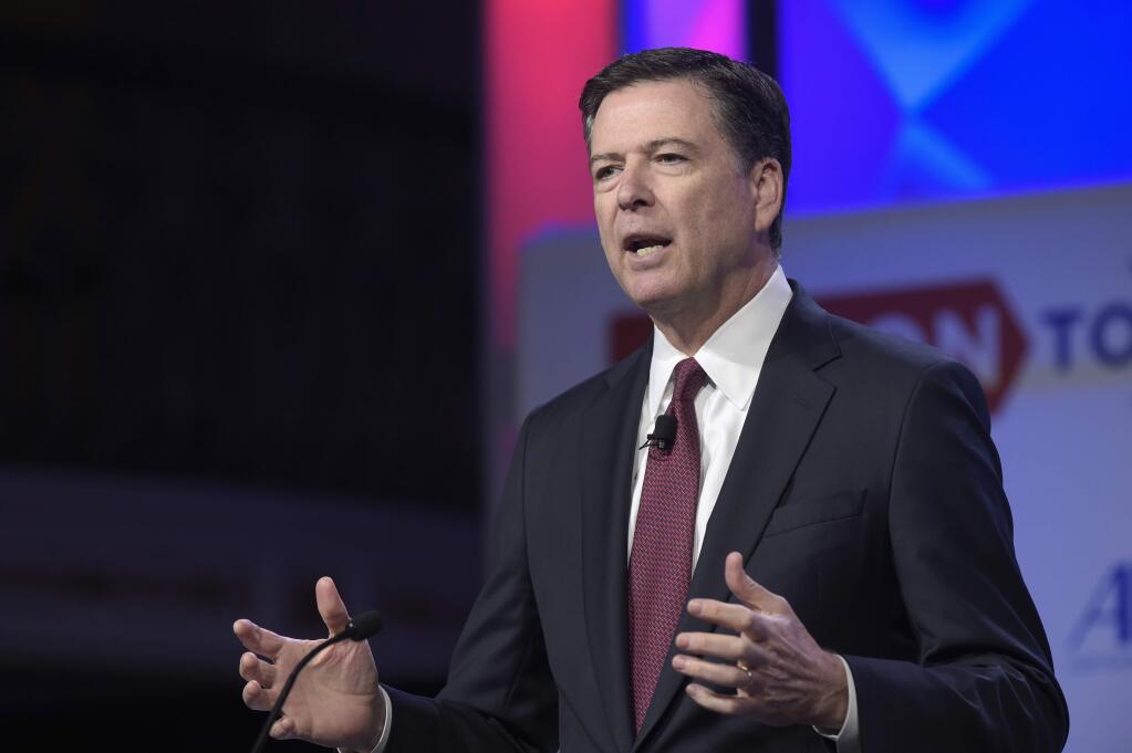 In this photo taken May 8, 2017, FBI Director James Comey speaks in Washington. President Donald Trump has fired Comey. In a statement released Tuesday, May 9, Trump says Comey's firing “will mark a new beginning” for the FBI. (AP Photo/Susan Walsh, File)