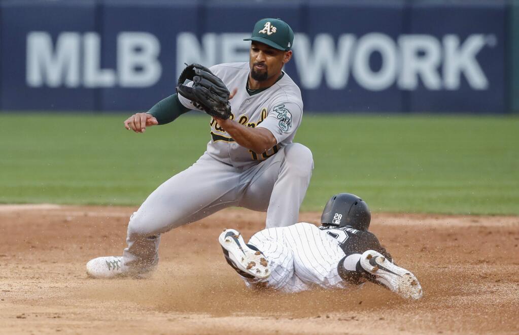 The Chicago White Sox's Leury Garcia, right, steals second base as the Oakland Athletics' Marcus Semien, left, is unable to tag him during the third inning Saturday, Aug. 10, 2019, in Chicago. (AP Photo/Kamil Krzaczynski)