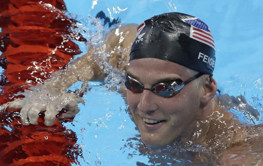 FILE - In this Aug. 2, 2016, file photo, United States James Feigen smiles during a swimming training session prior to the 2016 Summer Olympics in Rio de Janeiro, Brazil. Feigen was one of four American Olympic swimmers in connection to a story of being held at gunpoint and robbed several hours after the last Olympic swimming races ended. That claim began to unravel when police said that investigators could not find evidence to substantiate it. (AP Photo/Matt Slocum, File)