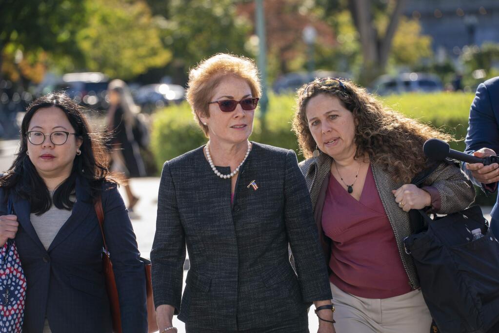 Former U.S. ambassador to Ukraine Marie Yovanovitch, center, arrives on Capitol Hill, Friday, Oct. 11, 2019, in Washington, as she is scheduled to testify before congressional lawmakers on Friday as part of the House impeachment inquiry into President Donald Trump. (AP Photo/J. Scott Applewhite)