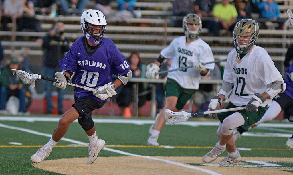 SUMNER FOWLER/FOR THE ARGUS-COURIERPetaluma's Isaiah Blomgren looks to pass as Casa Grande's Ian Mckissick and Dylan Guth rush up to defend in Petaluma's 18-17 win.