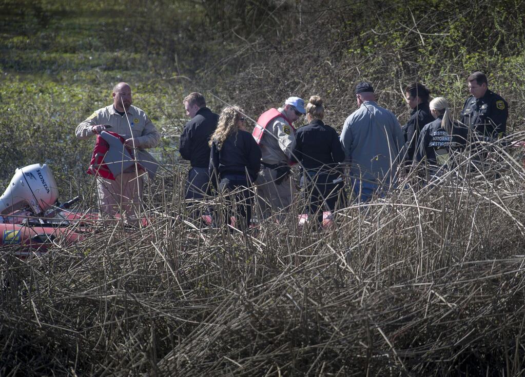 Yolo County investigators and officials prepare to leave a scene in a Yolo County slough after the discovery of the lifeless body of an infant in Knights Landing, Calif., Wednesday, Feb. 25, 2015. (AP Photo/The Sacramento Bee, Hector Amezcua)