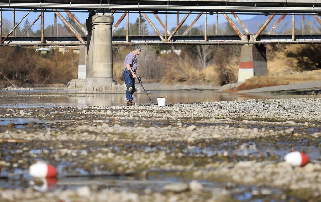 BEFORE: Hugh Beggs of Santa Rosa searches for coins in the middle of the Russian River at Healdsburg Veterans Memorial Beach on Tuesday, Jan. 14, 2013. (KENT PORTER/ PD FILE)
