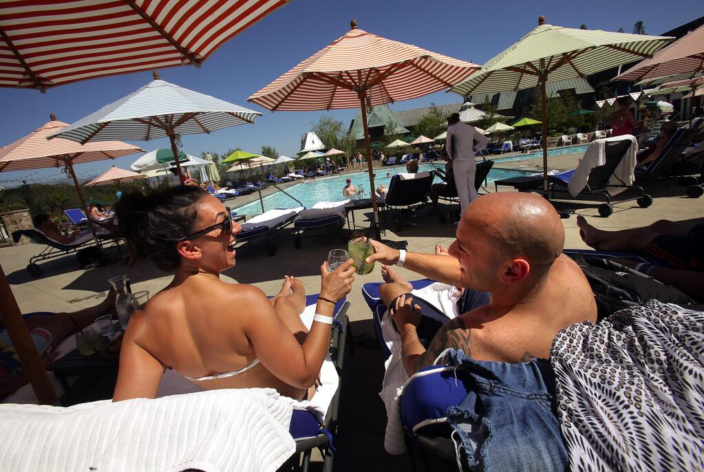 Raquel Garzon, left, toasts with boyfriend Matt Gozzi off New Jersey poolside at the Francis Ford Coppola Winery. (John Burgess/Press Democrat)