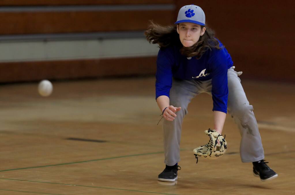 Kaija Bazzano, a junior at Analy High School, fields grounders during a rainy day workout on Tuesday, March 5, 2019. Bazzano is a member of the varsity baseball team. (Kent Porter / The Press Democrat)