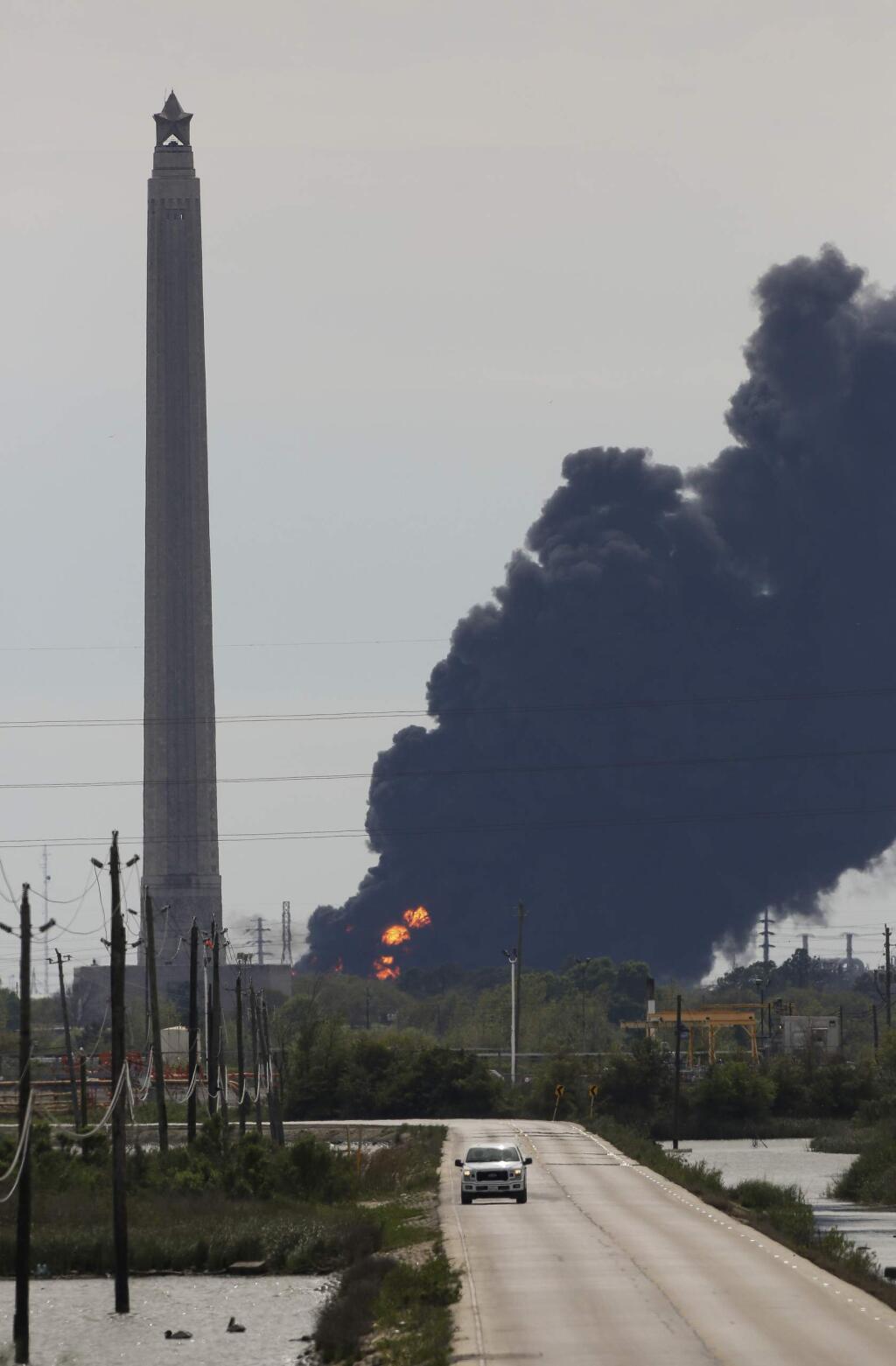 A view of the petrochemical fire at the Intercontinental Terminals Company, which is less than two miles southwest of the San Jacinto Memorial Monday, March 18, 2019, in Baytown, Texas. The large fire at a Houston-area petrochemicals terminal will likely burn for another two days, authorities said Monday, noting that air quality around the facility was testing within normal guidelines. ( Godofredo A. Vasquez/Houston Chronicle via AP)