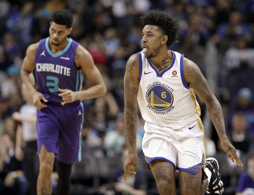 Golden State Warriors' Nick Young (6) reacts to making a basket against Charlotte Hornets' Jeremy Lamb (3) during the first half of an NBA basketball game in Charlotte, N.C., Wednesday, Dec. 6, 2017. (AP Photo/Chuck Burton)