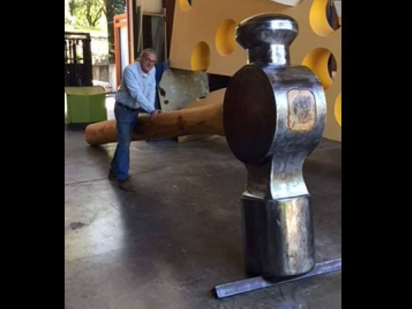 Artist Doug Unkrey and the hammer he created, stolen from Healdsburg's community center over the weekend. (COURTESY OF HEALDSBURG POLICE DEPARTMENT)