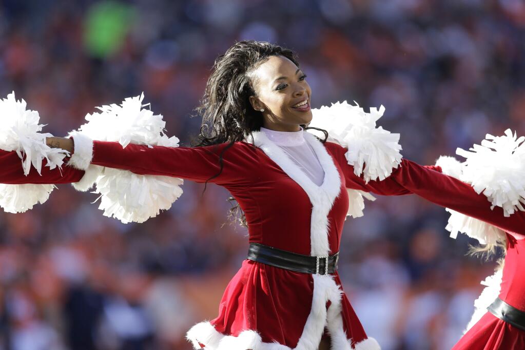 Denver Broncos cheerleaders perform during the first half in an NFL football game against the Buffalo Bills Sunday, Dec. 7, 2014, in Denver. (AP Photo/Joe Mahoney)