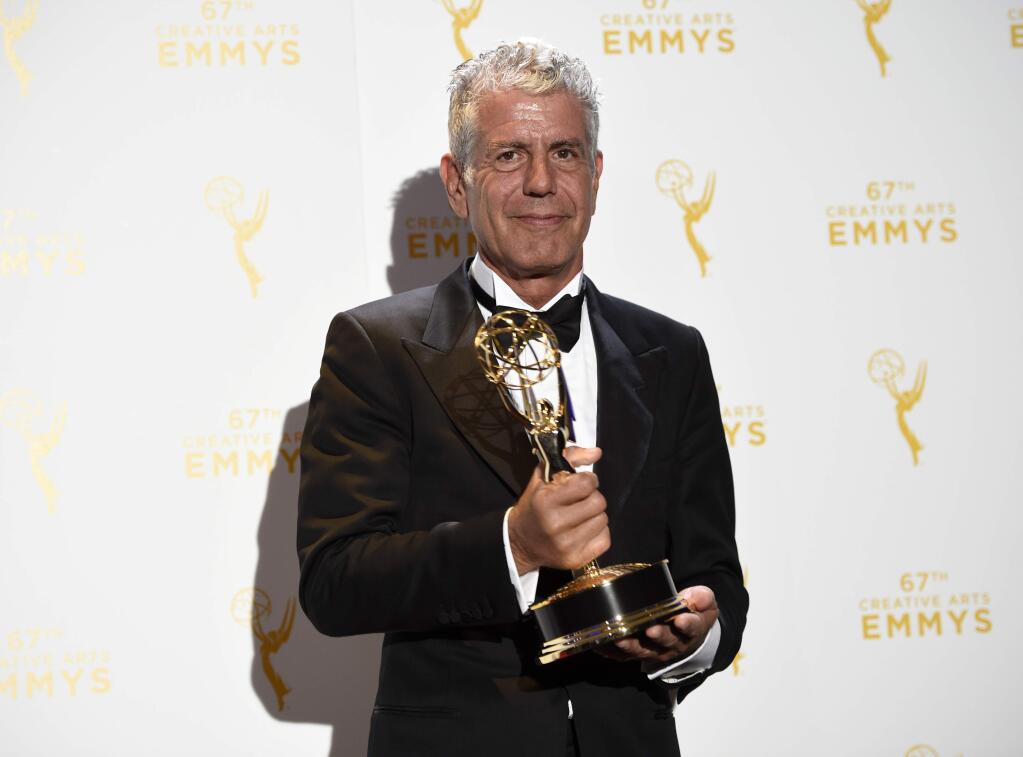 FILE - In this Saturday, Sept. 12, 2015 file photo, Anthony Bourdain, winner of the award for outstanding informational series or special for 'Anthony Bourdain Parts Unknown,' poses with his trophy in the press room at the Creative Arts Emmy Awards in Los Angeles. On Friday, June 8, 2018, Bourdain was found dead in his hotel room in France, while working on his CNN series on culinary traditions around the world. (Photo by Chris Pizzello/Invision/AP)