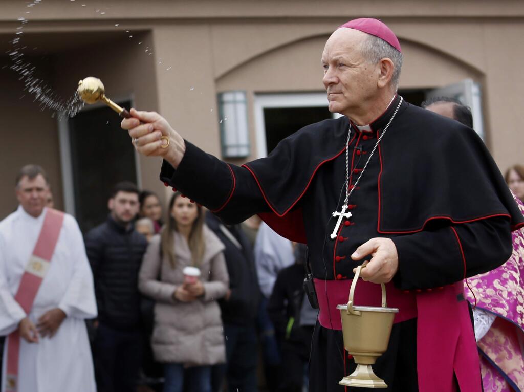 Santa Rosa Bishop Robert Vasa sprinkles holy water to bless a new prayer garden at Our Lady of Guadalupe Catholic Church on Sunday, December 11, 2016 in Windsor, California . (BETH SCHLANKER/The Press Democrat)
