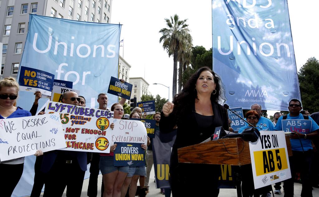FILE -- In this Aug. 28, 2019, file photo, Assemblywoman Lorena Gonzalez, D-San Diego, speaks at rally calling for passage of her measure to limit when companies can label workers as independent contractors at the Capitol in Sacramento, Calif. Gov Gavin Newsom signed the bill, AB5, aimed at giving wage and benefit protections to ride share drivers and workers in other industries on Wednesday, Sept. 18, 2019. (AP Photo/Rich Pedroncelli, File)