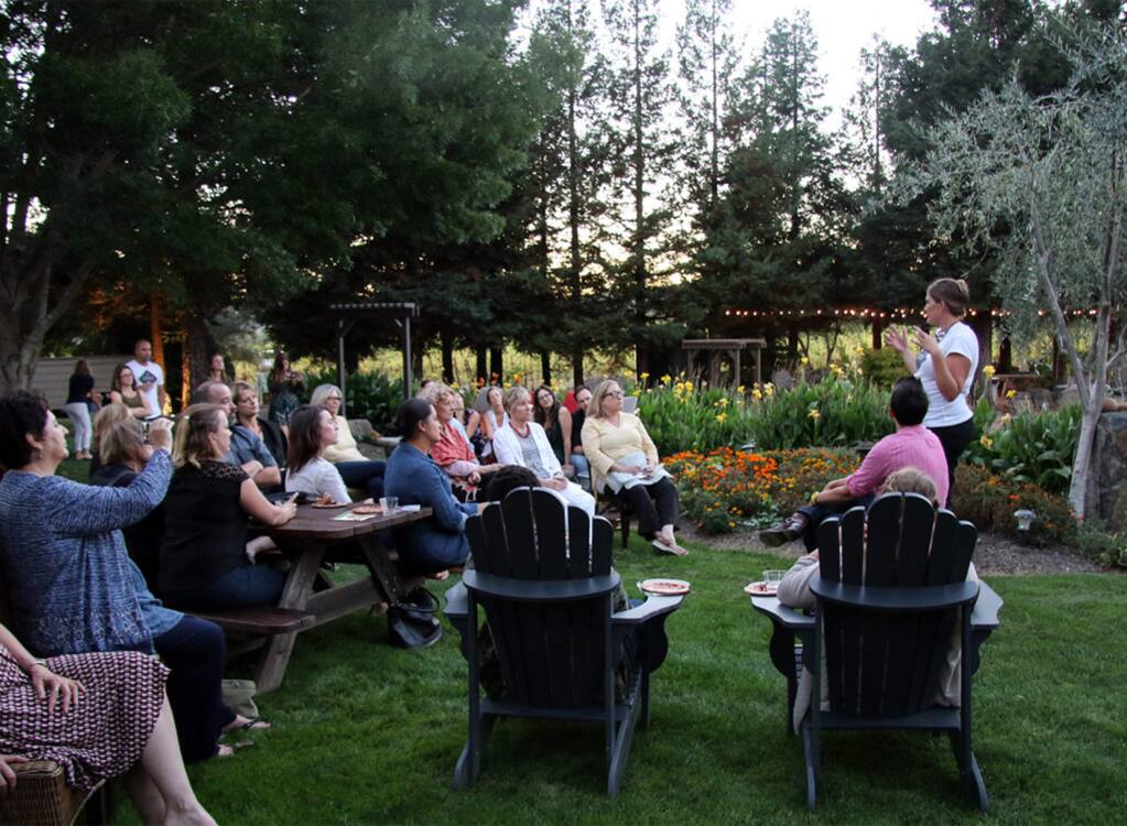 An invite-only gathering for women hosted by Garden Society CEO Erin Gore, right, standing, at a private home is aimed at women who are seeking relief from both everyday stresses and deeper discomfort associated with chronic pain and aging. Gore's Santa Rosa-based marijuana edibles company uses social gatherings like this to both inform and engage a growing audience of cannabis users. (HEATHER IRWIN/ PD)