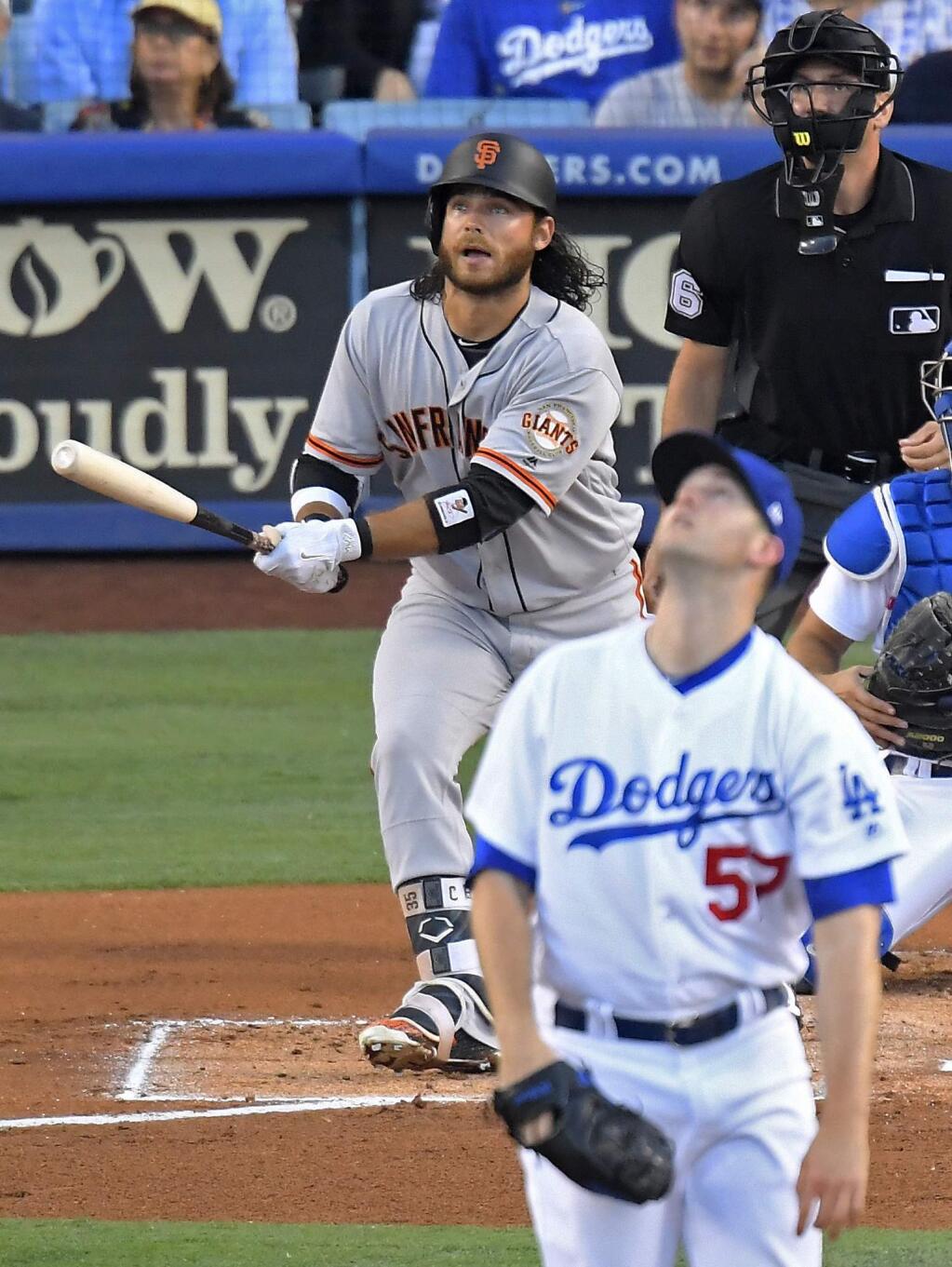 San Francisco Giants' Matt Moore watches his solo home run off Los Angeles Dodgers starting pitcher Alex Wood, front, during the second inning of a baseball game, Friday, July 28, 2017, in Los Angeles. (AP Photo/Mark J. Terrill)