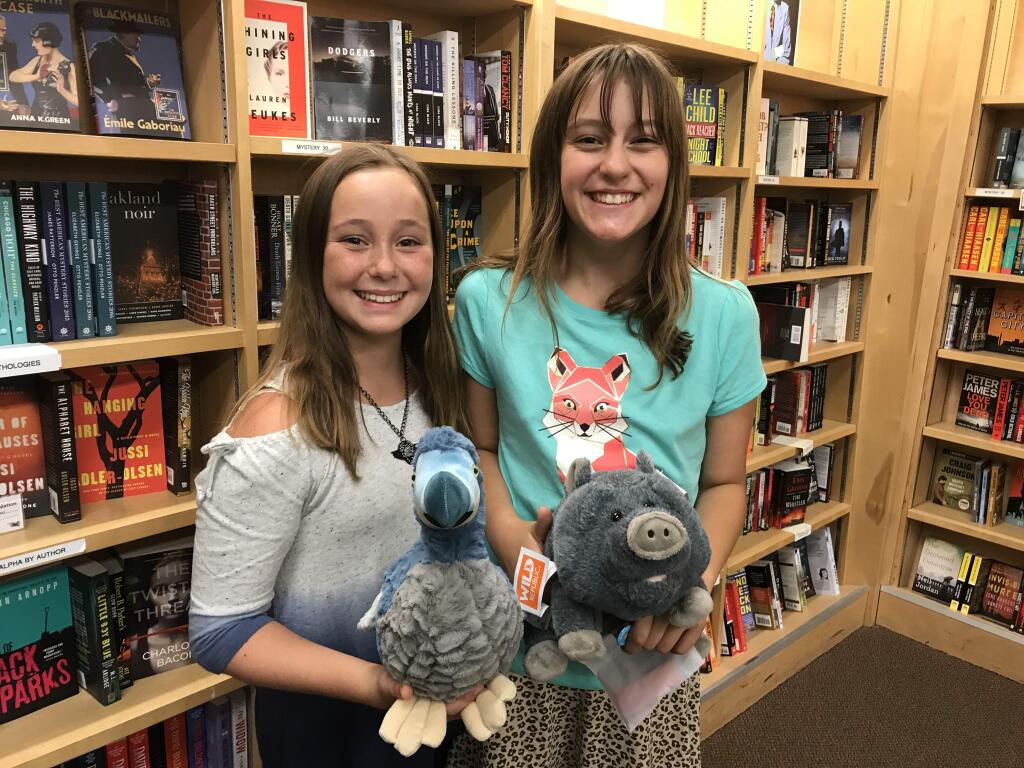 AUTHORS AND ANIMALS: Lorelei Wright with Milicent the Dodo (left) and Madeline Wright with Frannie the Pig (right).