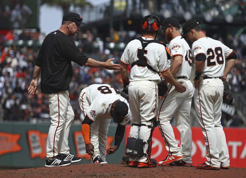 San Francisco Giants manager Bruce Bochy, left, relieves pitcher Sam Dyson (49) in the seventh inning against the Arizona Diamondbacks Wednesday, April 11, 2018, in San Francisco. (AP Photo/Ben Margot)