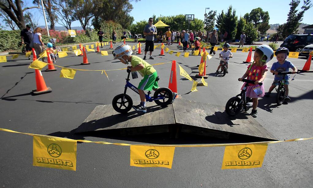 Strider bikes and Bell helmet's were part of a giveaway at CamelBak headquarters in Petaluma, Wednesday June 29, 2016. About 80 bikes were given out to kids in an order to learn balance before graduating to pedal bikes. (Kent Porter / Press Democrat) 2016