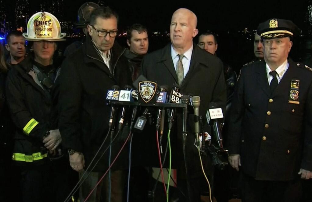 In this image made from video provided by WNYW, New York City Police Commissioner James O'Neill speaks during a press conference a deadly helicopter crash in New York on Sunday, March 11, 2018. A helicopter crashed into New York City's East River Sunday night and flipped upside down in the water, killing at least a few people aboard and leaving some others in critical condition, officials said. New York City Fire Department Commissioner Daniel Nigro stands at center left. (WNYW via AP)