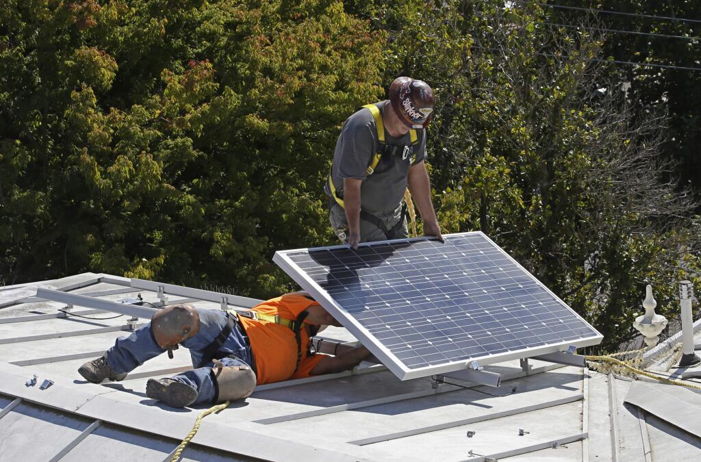 FILE-- In this Oct. 16, 2015 file photo a solar panel is installed on the roof of the Old Governor's Mansion State Historic Park in Sacramento, Calif. After extensive renovations, Gov. Jerry Brown and his wife, Anne Gust Brown moved into the mansion in late 2015, becoming the first chief executive to live in the home since Ronald Reagan in 1967. The California Energy Commission will take up a proposal, Wednesday, May 9, 2018 , to require solar panels on new residential homes and low-rise apartment buildings up to three starting in 2020. (AP Photo/Rich Pedroncelli, File)