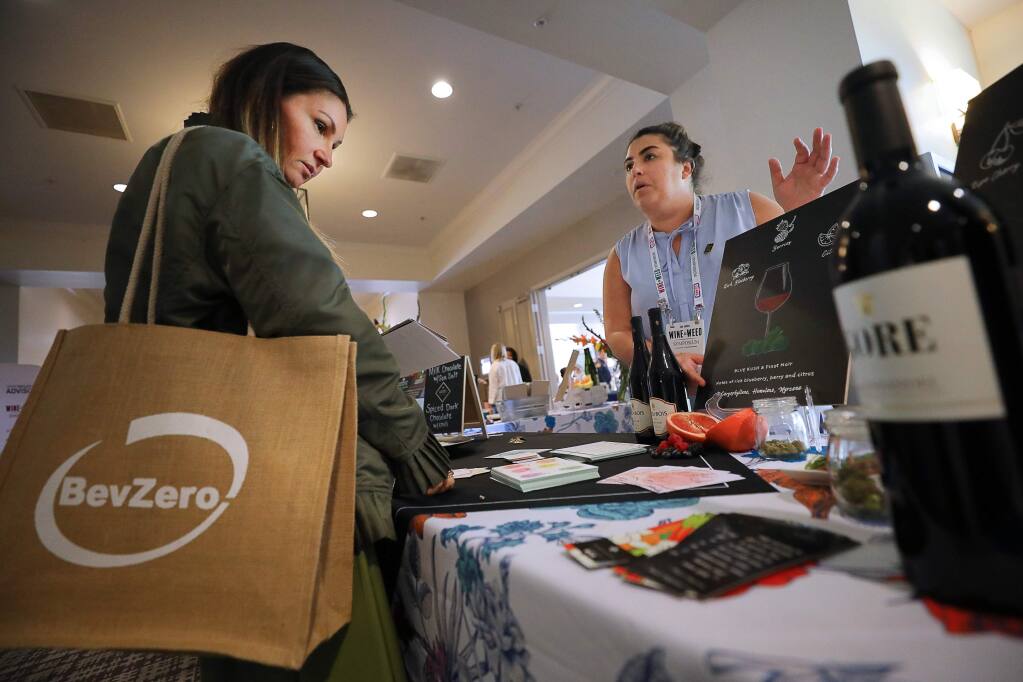 Cristina Pavelka, of the Garden Society, talks to Anna Becker about marijuana and wine pairings during the 3rd Annual Wine & Weed Symposium, in Santa Rosa on Thursday, August 8, 2019. (Christopher Chung/ The Press Democrat)